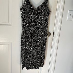 Vintage and still has the tags on it! Silk beaded dress!